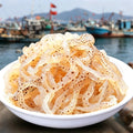 Translucent jellyfish strips with speckled markings in a bowl